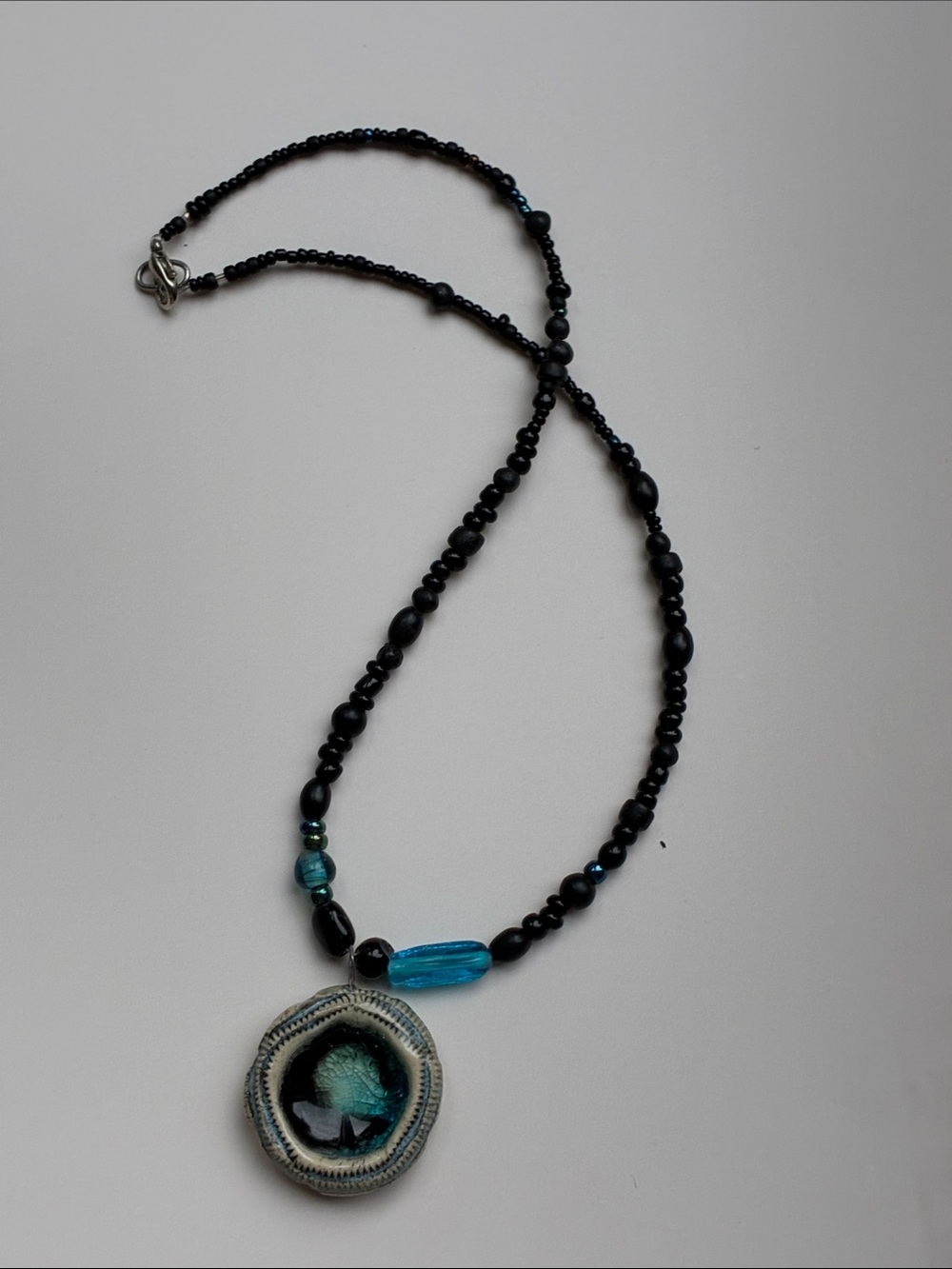 Handcrafted artisan glass and ceramic  Necklace with Blue Accent and Carved